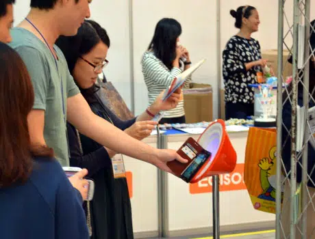 Exhibition visitors try out SK Planet's colourful NFC touchpoints