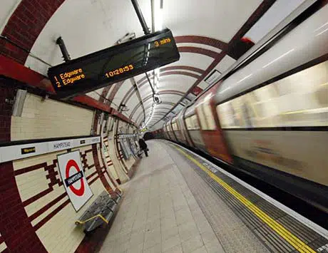 A London Underground tube train passes through a station