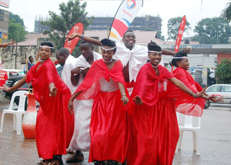UGANDA: Dancers celebrate the launch of Airtel mobile payments at a Total gas station