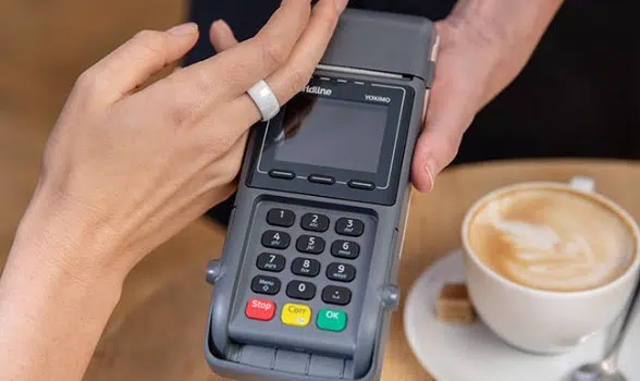 A person makes a contactless payment with an NFC ring