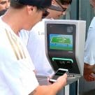 Fans use their iPhones and Apple Watches at a contactless turnstile to get in to an LAFC match