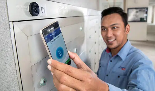 A mail carrier uses an NFC phone to record a mailbox delivery  