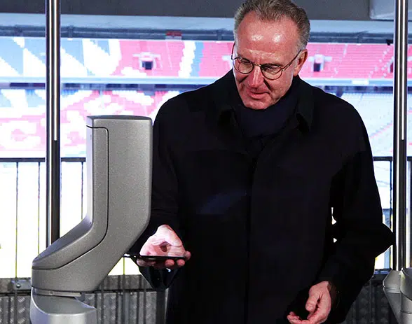 Two-time European Footballer of the Year and now Bayern Munich CEO Karl-Heinz Rummenigge tries out the NFC access gates at the Allianz Arena