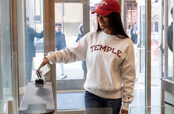 A student opens a barrier using an NFC version of Temple University's Owl card
