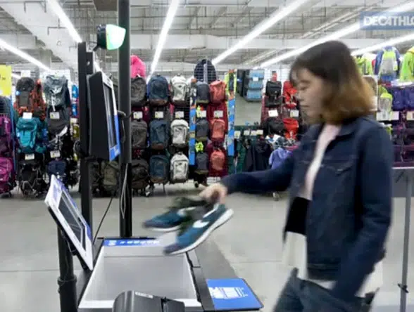 Woman scans trainers at self-checkout