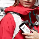 Woman in red sports gear holding smartphone