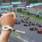 Hand with tappit wristband and F1 race track and cars