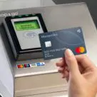 Contactless card being tapped on payment terminal