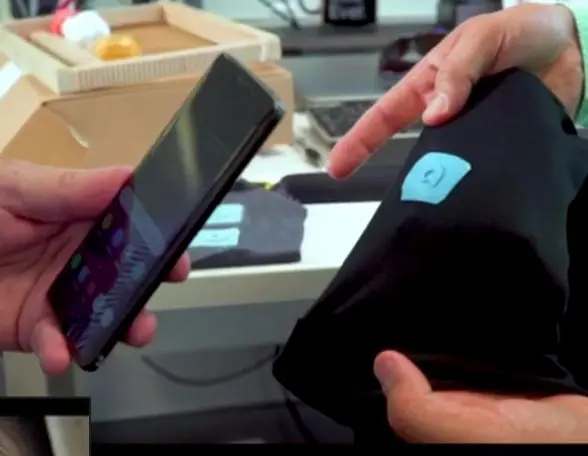 Smartphone being tapped on NFC tag on clothing