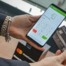 Debit card being tapped on NFC phone mPOS