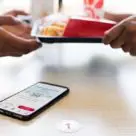 Smartphone on table with fast food