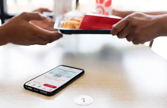 Smartphone on table with fast food