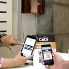 2 smartphones held in hands being used to make qr payment