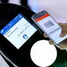 A person using an NFC phone as a virtual Nol card