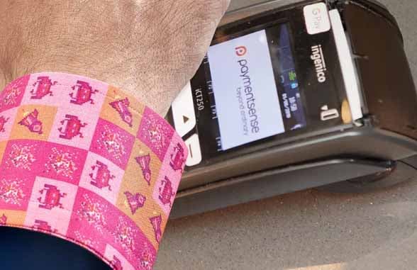 Shirt sleeve with NFC chip being tapped to contactless payment terminal
