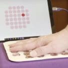 Fingers placed on NFC epidermal VR pad