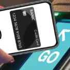 Hand with nfc contactless smartphone over ticket reader