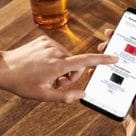 Finger tapping smartphone showing Finder for Samsung Pay