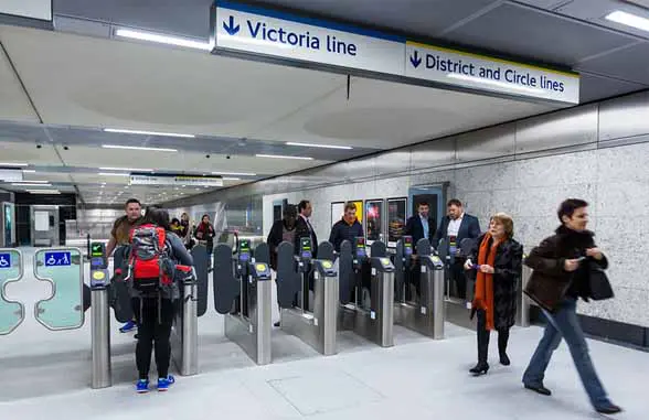 People passing TfL ticket barriers at Victoria Tube station