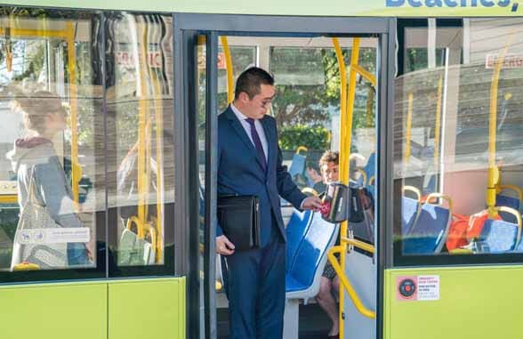 Man using contactless card to board MetLink New Zealand bus
