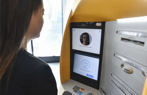 Woman using Caixabank Store biometric atm