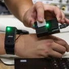 Prototype wearable showing smartwatch transferring data to laptop