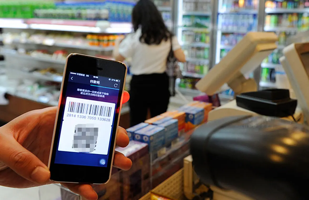Chinese consumer using smartphone to make QR mobile payment 
