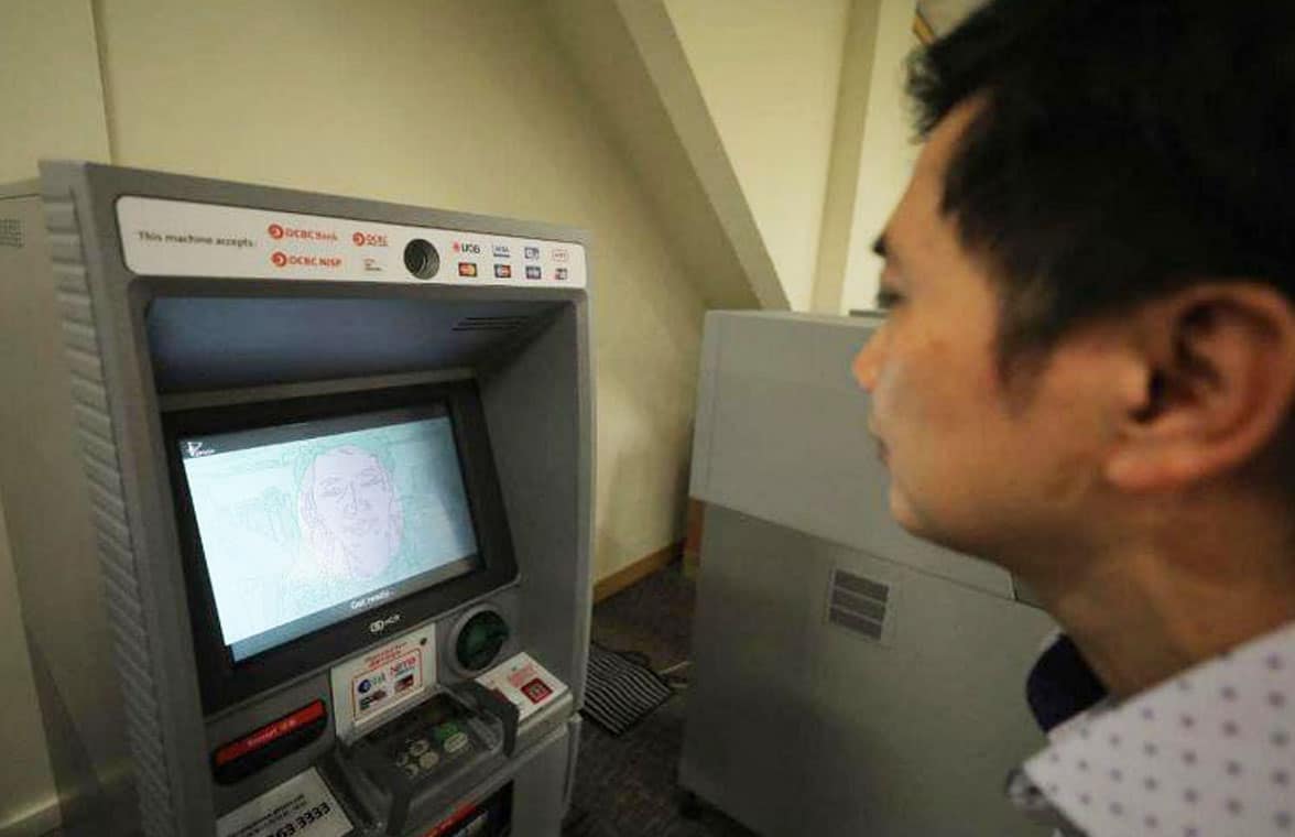 Man using OCBC Bank facial recognition ATM in Singapore