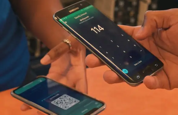 Shoppers using East Caribbean Central Bank digital currency on their smartphones