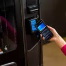 Woman making digital payment at vending machine