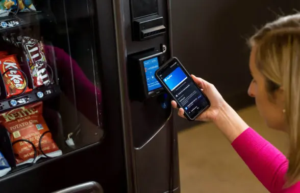 Woman making digital payment at vending machine