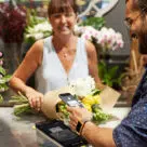 contactless payment being made in florist using digital wallet on Apple iPhone