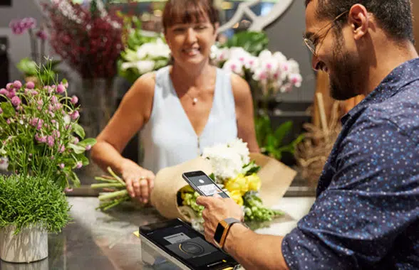 contactless payment being made in florist using digital wallet on Apple iPhone
