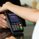 Walletmore NFC implant being used by consumer to make a contactless payment with their hand