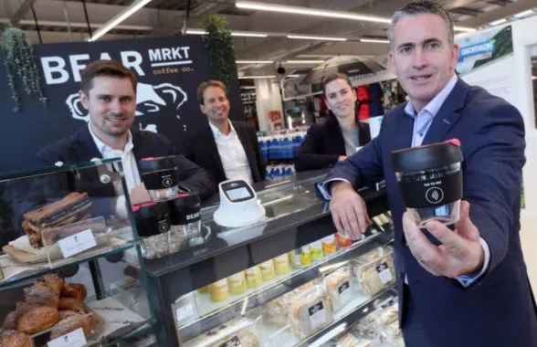 Bear Market Coffee shop in Dublin with man holding reusable contactless payments cup