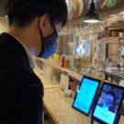 Japanese customer taking part in trial of face payments wearing a mask
