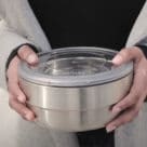 Hands holding reusable NFC food container