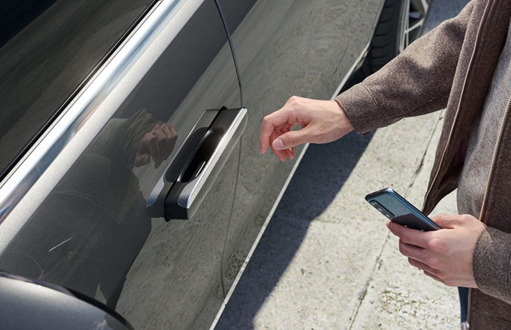 Man opening Hyundai Genesis V90 using Apple NFC car key 