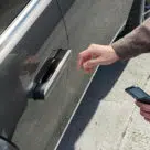 Man opening Hyundai Genesis V90 using Apple NFC car key