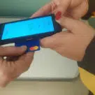 Correos postal delivery staff accepting contactless payments on Android device in Spain