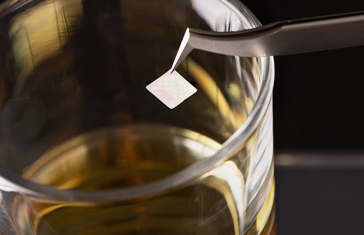 EEdible QR code being placed into glass to authenticate whisky