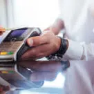 Contactless card being tapped on payment device