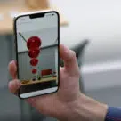 Apple iphone with iOS16 and camera-assisted object location using AR jects such as museum exhibits more accurately and allow them to locate objects in the “AR world”, Apple says.