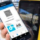Smartphone with QR code being used for fare payment on a Helsinki Regional Transport validator