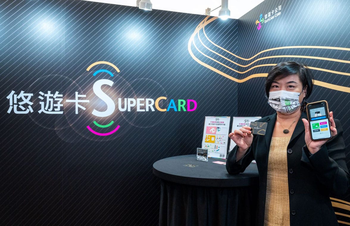 Woman holding smartphone with easycard supercard logo in the background
