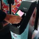 Person making contactless open loop contactless payment with their smartphone at Queensland rail station