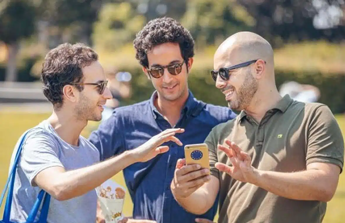 Three men looking at European Digital Identity Wallet on phone
