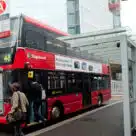 Passenger getting on TfL bus at London Bridge station