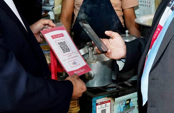 Customer using Bangladesh Bank's interoperable QR code payments system to pay for goods with their mobile