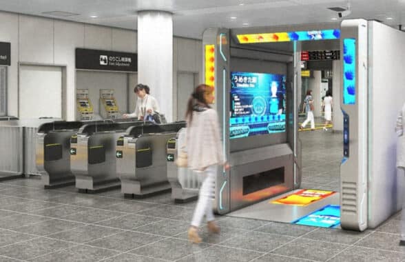 Woman entering contactless biometric fare payments gate at rail station in Osaka